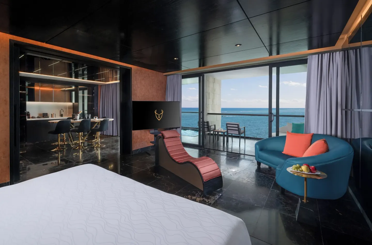Diamond Ocean-View Jacuzzi Suite with bed, lounge seating and balcony at Desire Riviera Maya Resort.