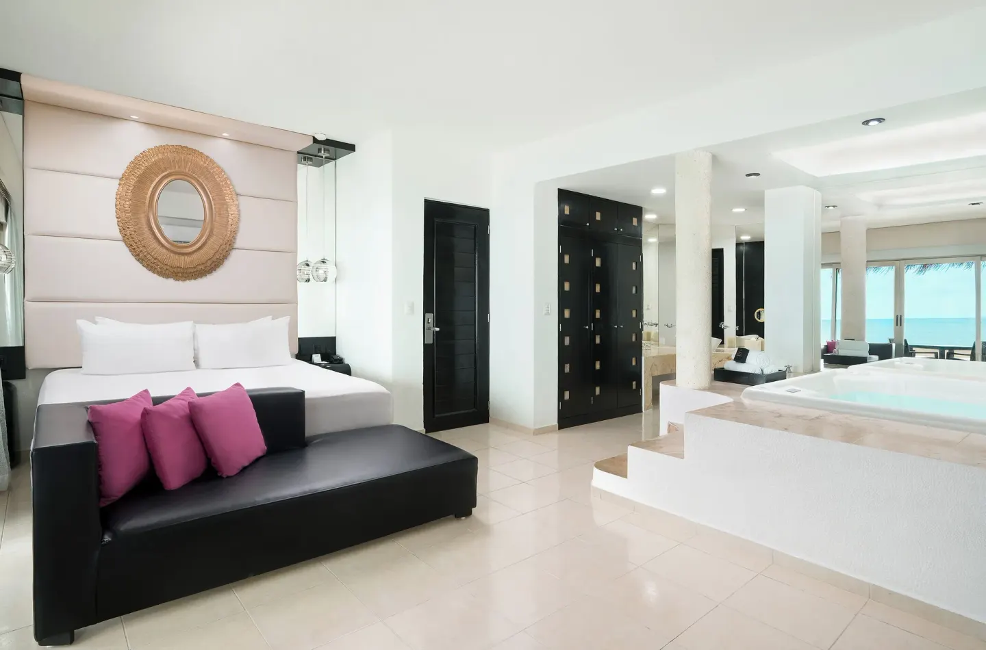 Passion Suite king bed, lounge sofa, and soaking tub at Desire Riviera Maya Resort.