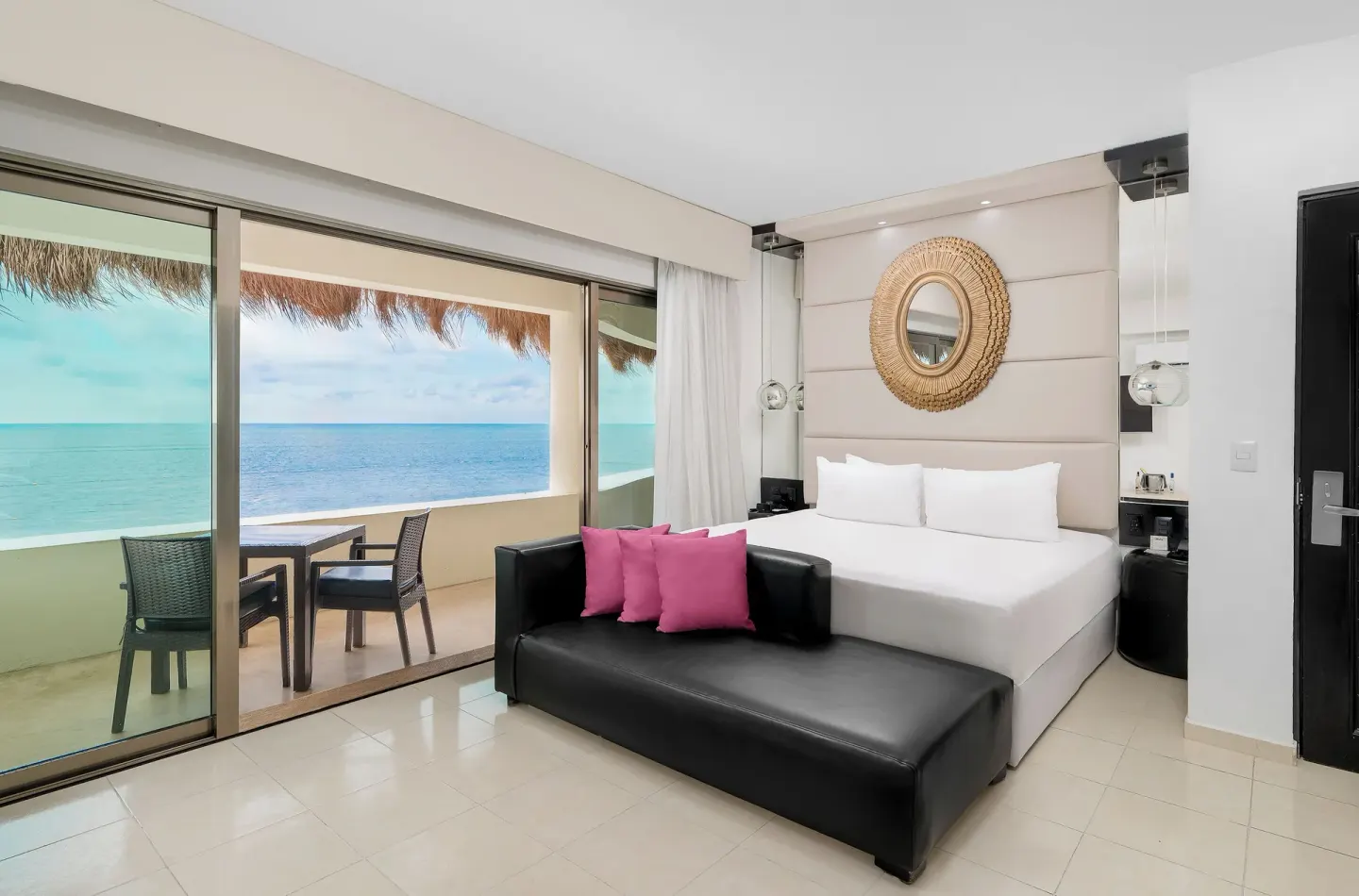 Passion Suite king bed and balcony with ocean view at Desire Riviera Maya Resort.
