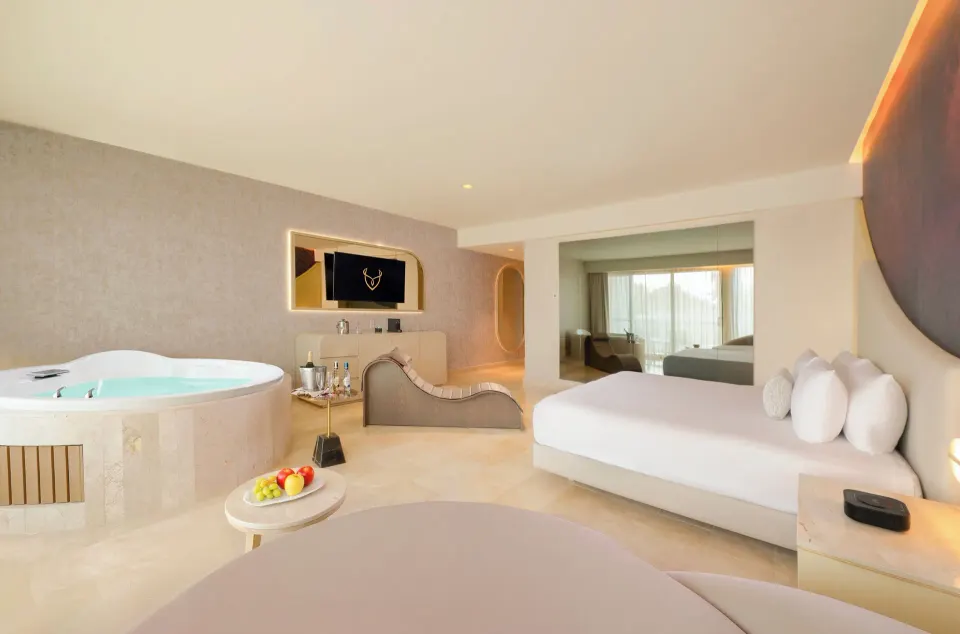 Seductive Pool View Jacuzzi Suite with king bed, daybed, and whirlpool tub at Desire Riviera Maya Resort.