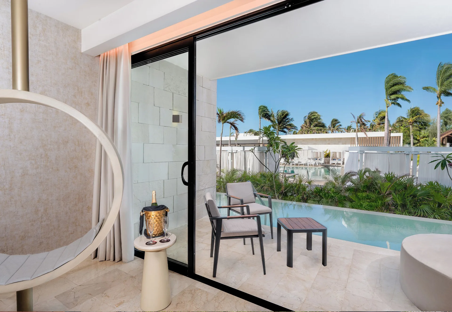 Swim-up suite terrace seen from inside at Desire Riviera Maya Resort.