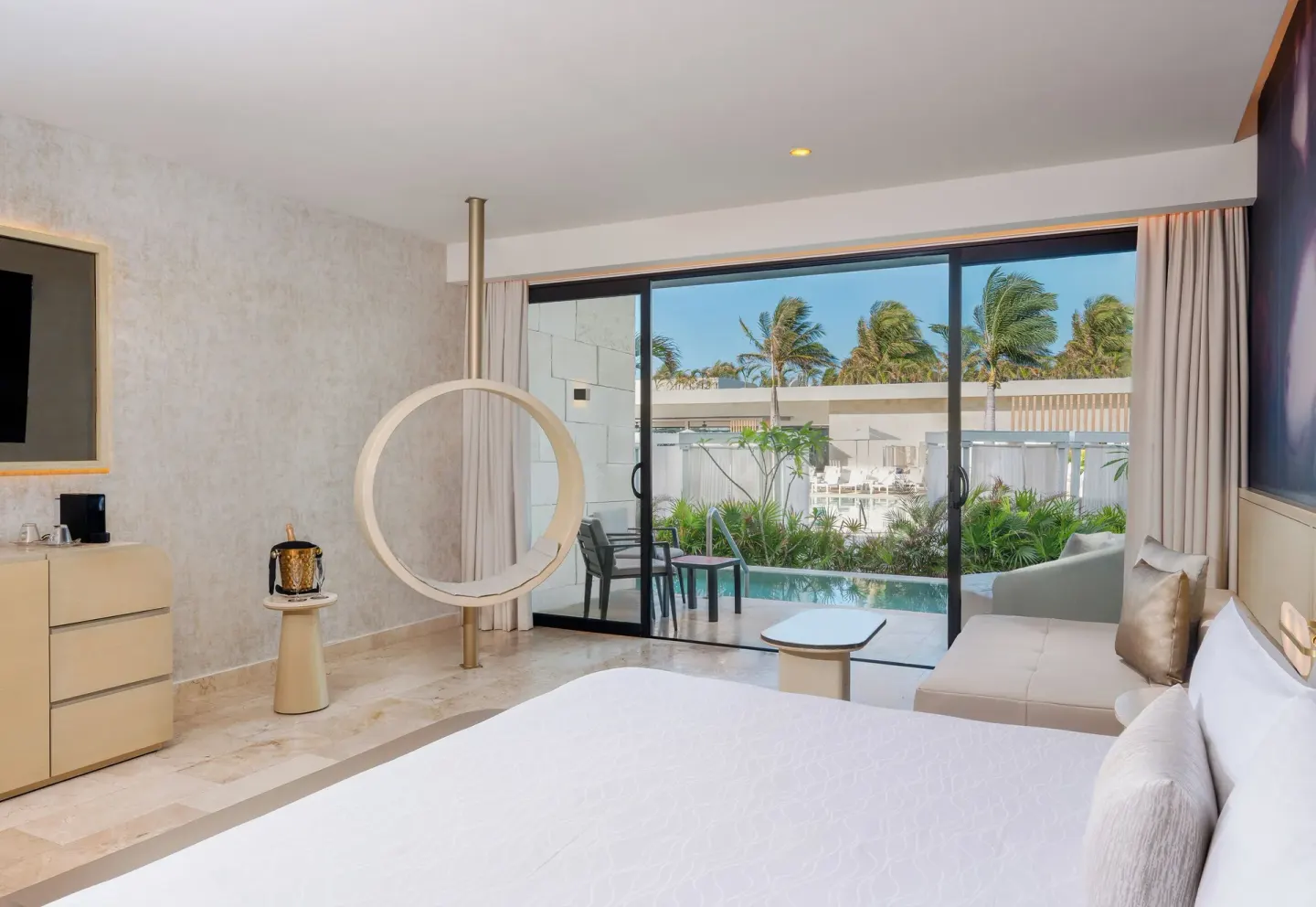 Seductive Pool-View Swim-up Suite king bed facing the swim-up patio at Desire Riviera Maya Resort.
