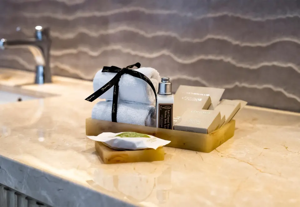Bathroom vanity amenities in a Superior Garden View Room at Desire Riviera Maya Resort.