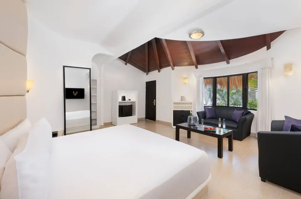 Superior Garden View king bed room with vaulted wood ceiling at Desire Riviera Maya Resort.