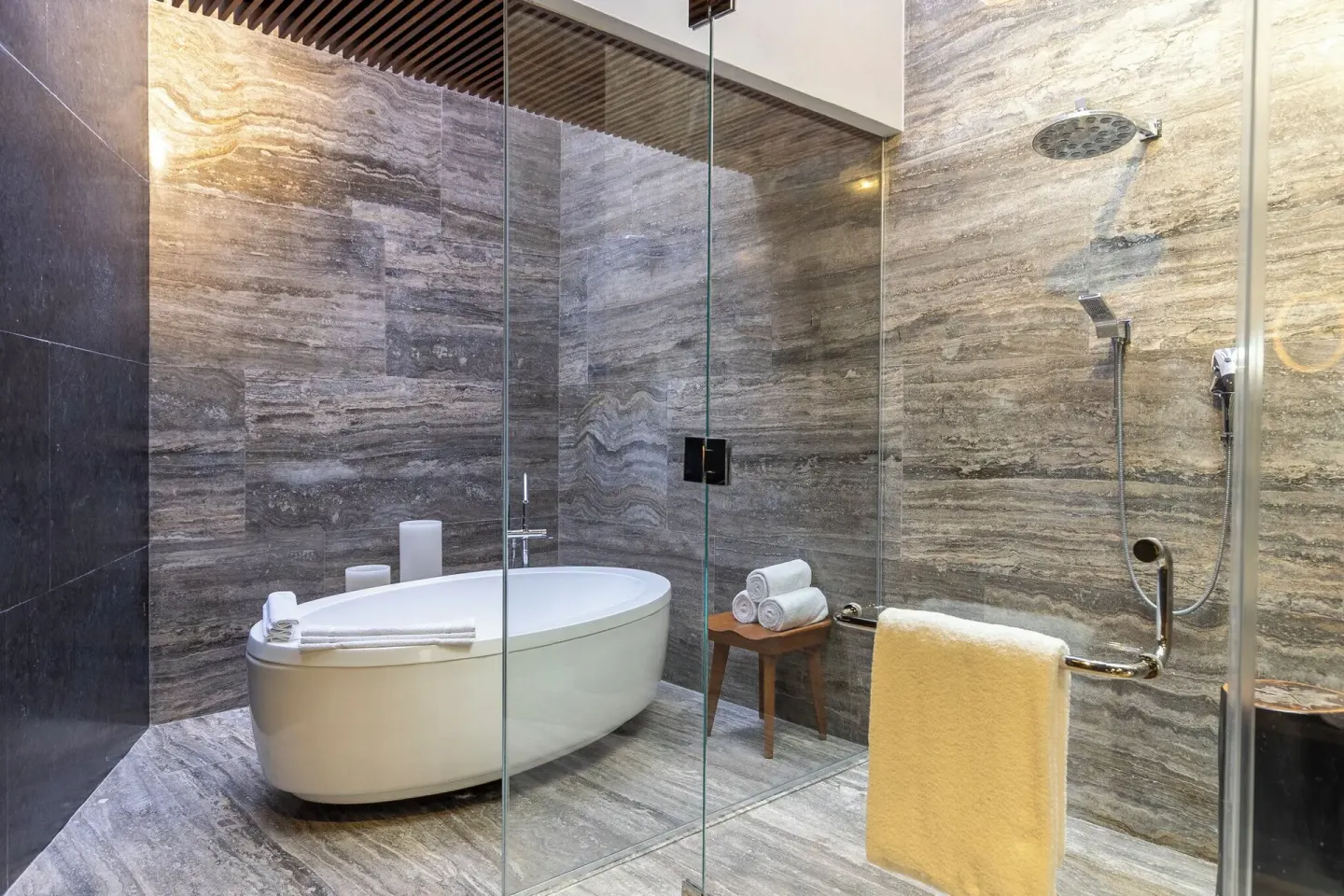 Bathroom with soaking tub and glass shower at Devossion By Live Aqua Playa del Carmen.