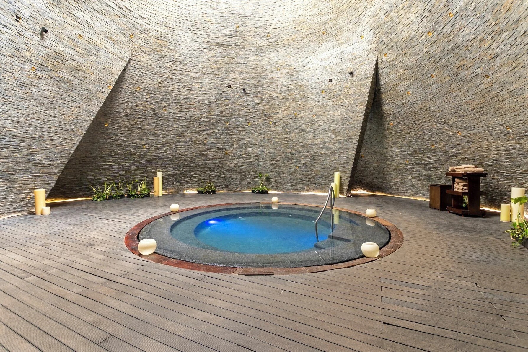 Circular spa pool in a stone-walled room at Devossion By Live Aqua Playa del Carmen.