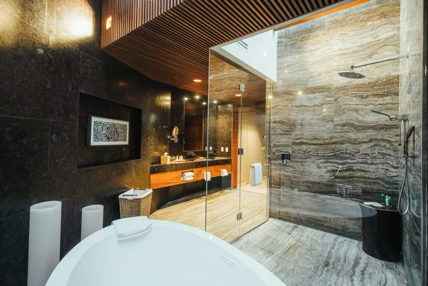 Guest bathroom with soaking tub and glass shower at Devossion By Live Aqua Playa del Carmen.