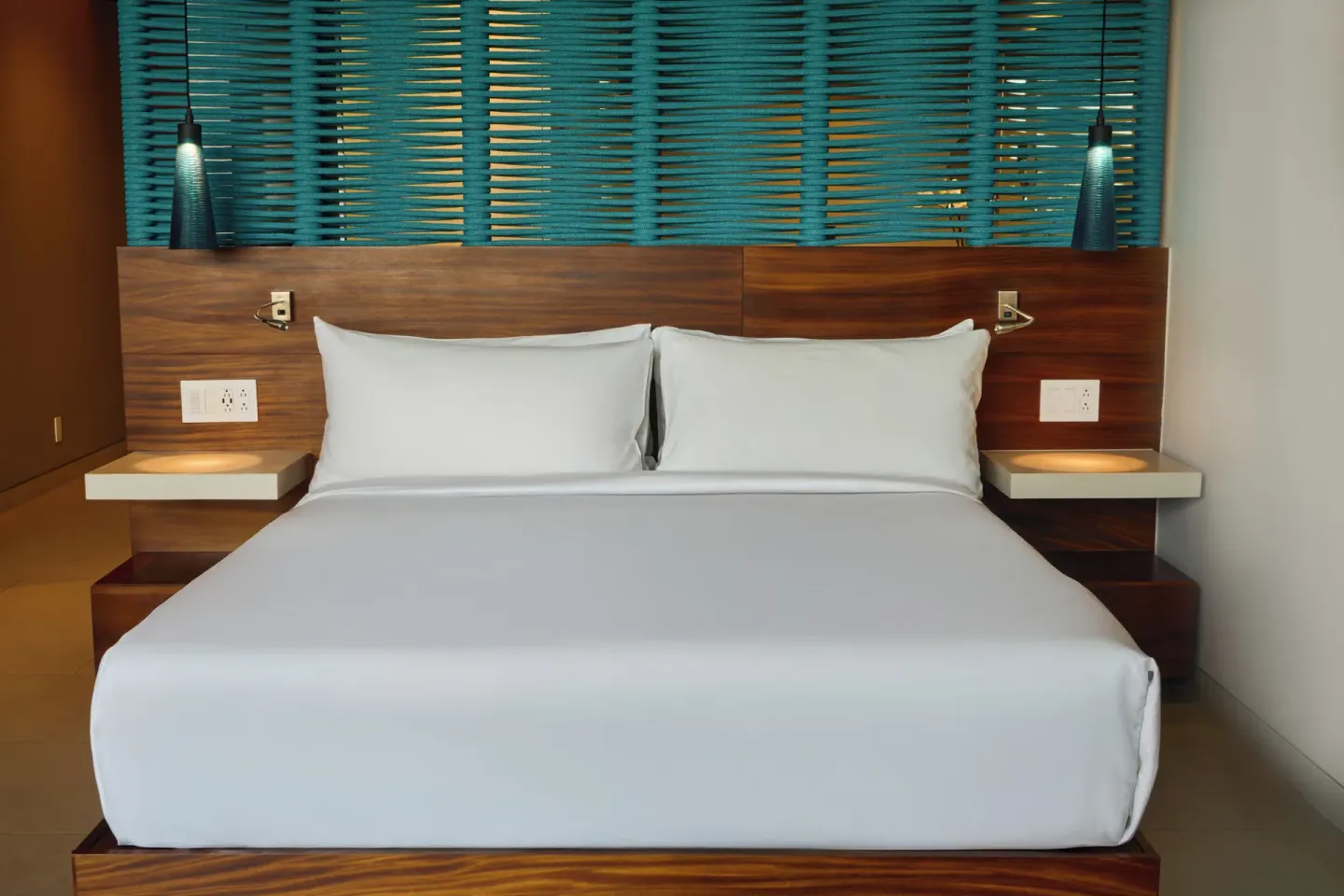 King bed with turquoise headboard detail at Devossion By Live Aqua Playa del Carmen.