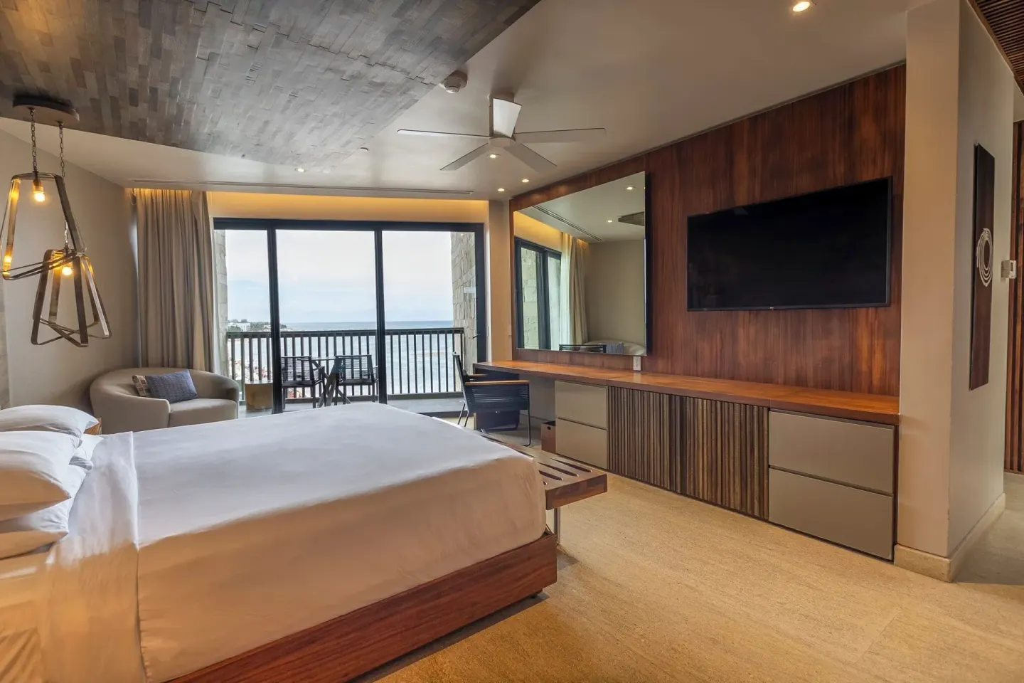 King-bed guest room with ocean-facing balcony at Devossion By Live Aqua Playa del Carmen.
