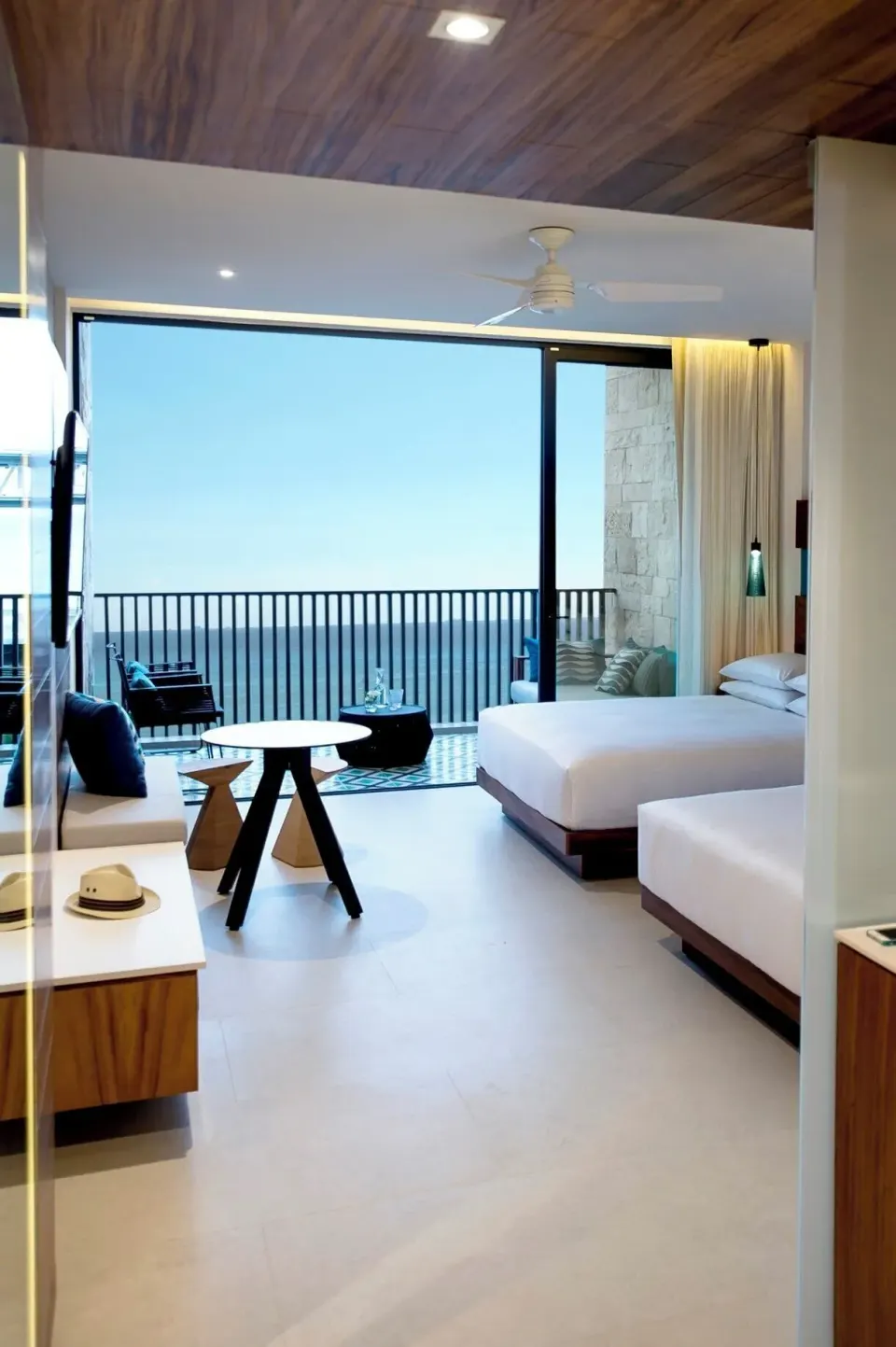 Guest room with two beds and balcony at Devossion By Live Aqua Playa del Carmen.