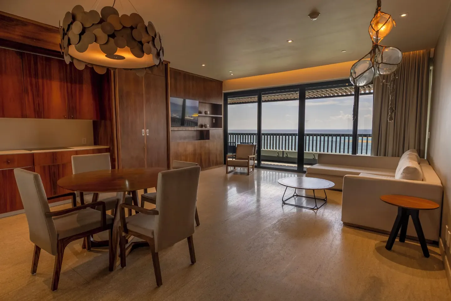 Oceanfront suite living and dining area at Devossion By Live Aqua Playa del Carmen.