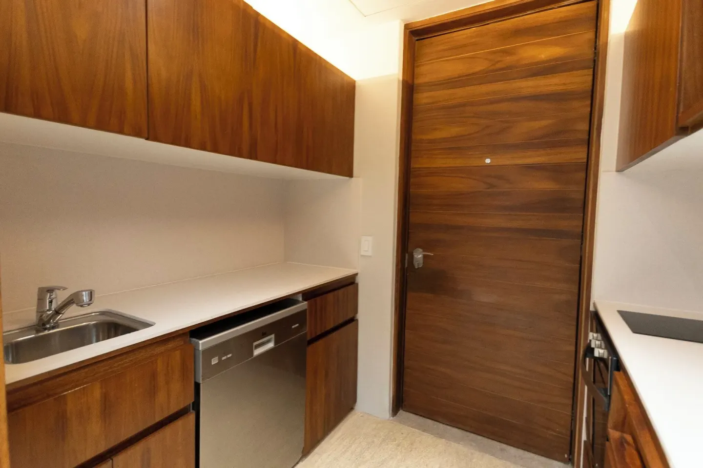Suite kitchenette with wood cabinetry at Devossion By Live Aqua Playa del Carmen.