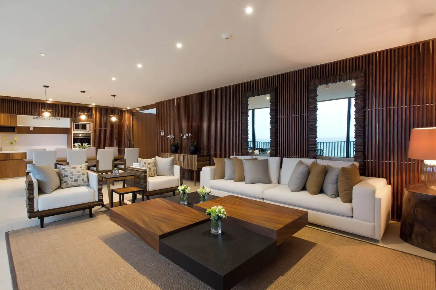 Suite living room with sofas and dining area at Devossion By Live Aqua Playa del Carmen.