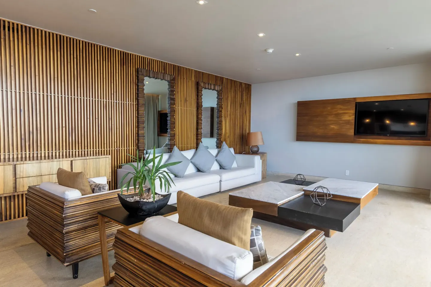 Suite living room with wood-slat wall at Devossion By Live Aqua Playa del Carmen.