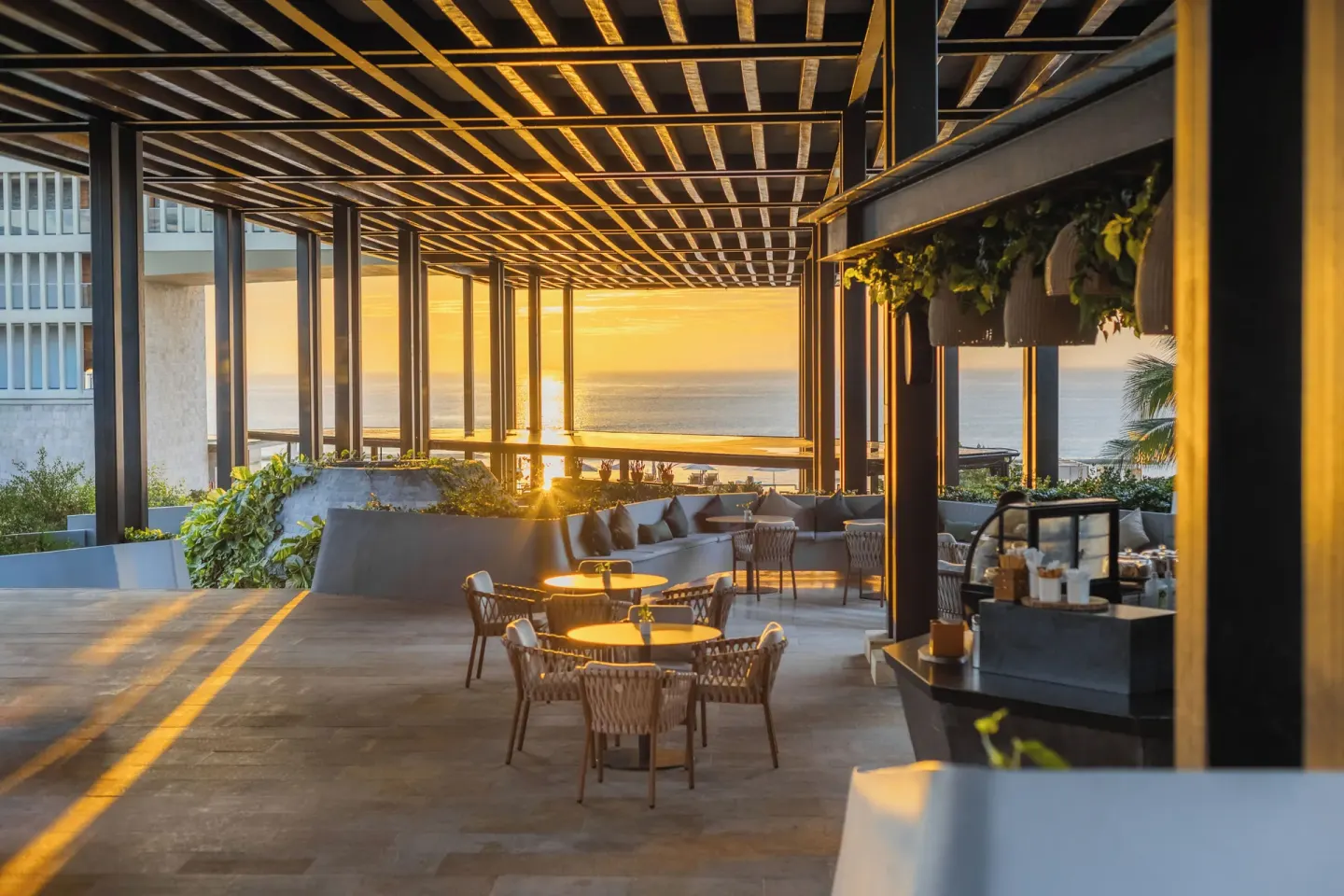Sunset terrace seating overlooking the ocean at Devossion By Live Aqua Playa del Carmen.