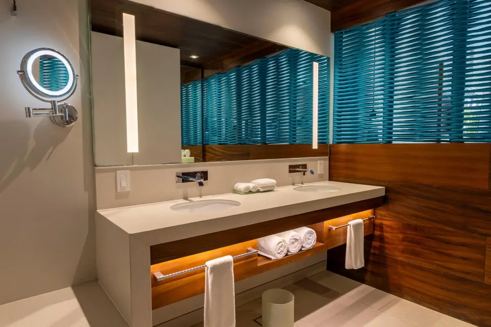 Premium Garden View bathroom vanity with blue blinds at Devossion By Live Aqua Playa del Carmen.