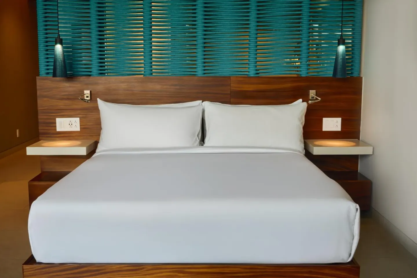 Premium Partial Ocean View king bed at Devossion By Live Aqua Playa del Carmen with blue slatted wall