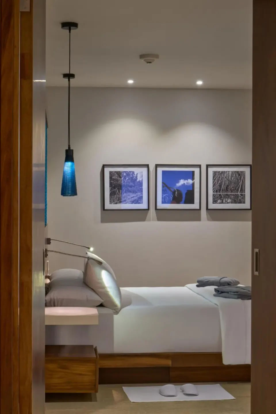 Premium Partial Ocean View bed seen through doorway at Devossion By Live Aqua Playa del Carmen