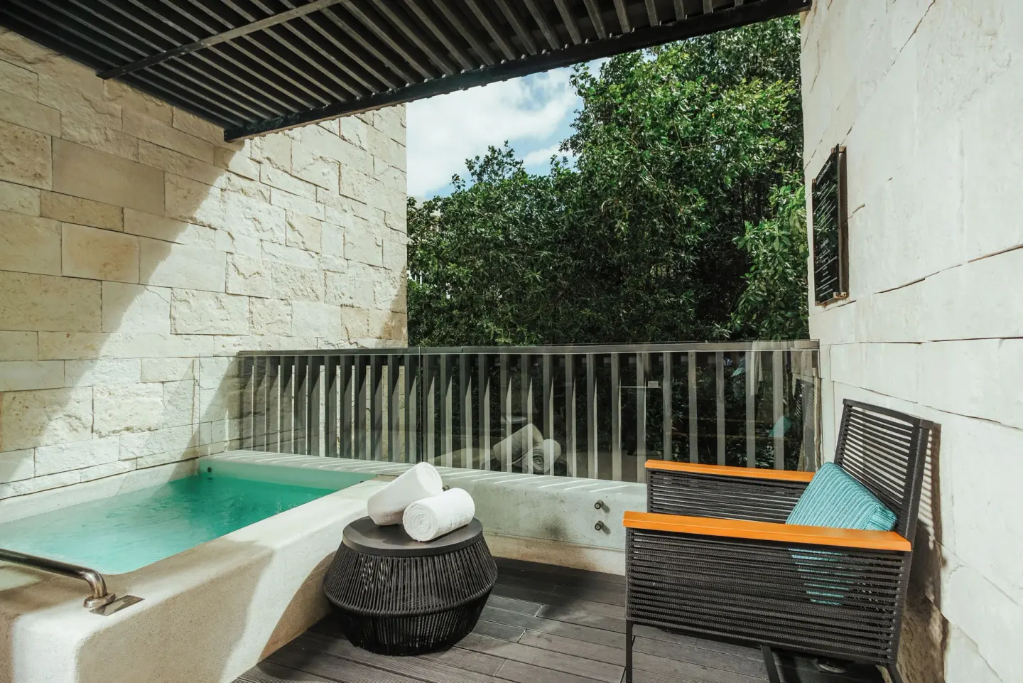 Covered plunge pool balcony with towels at Devossion By Live Aqua Playa del Carmen.