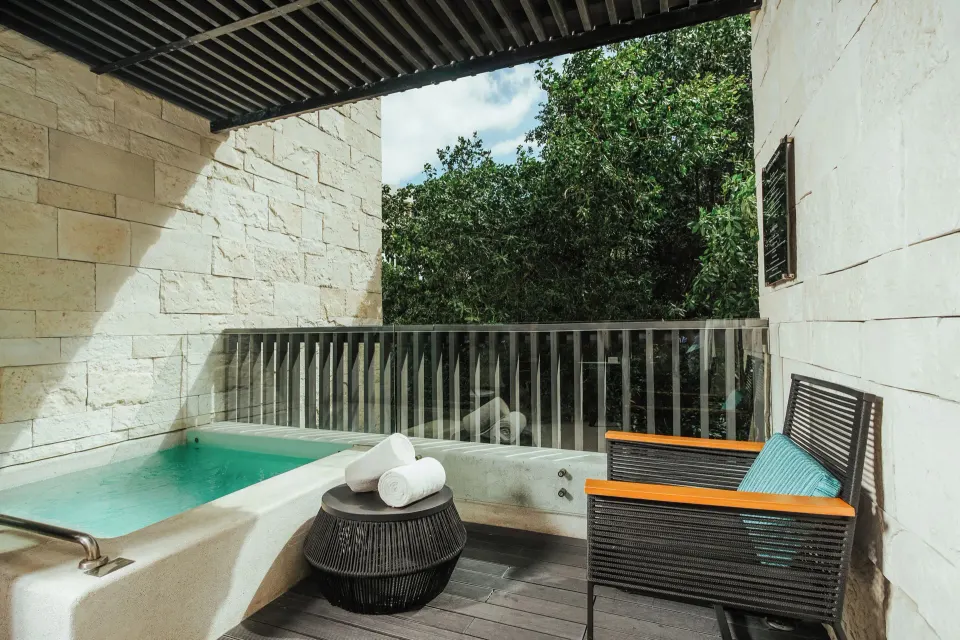 Covered plunge pool balcony with towels at Devossion By Live Aqua Playa del Carmen.