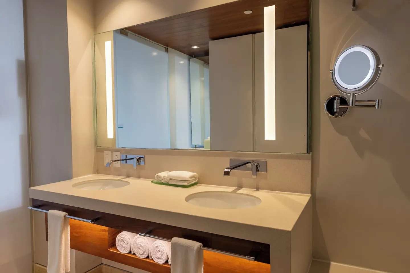 Double-sink vanity with lit mirrors in a Premium Room at Devossion By Live Aqua Playa del Carmen.
