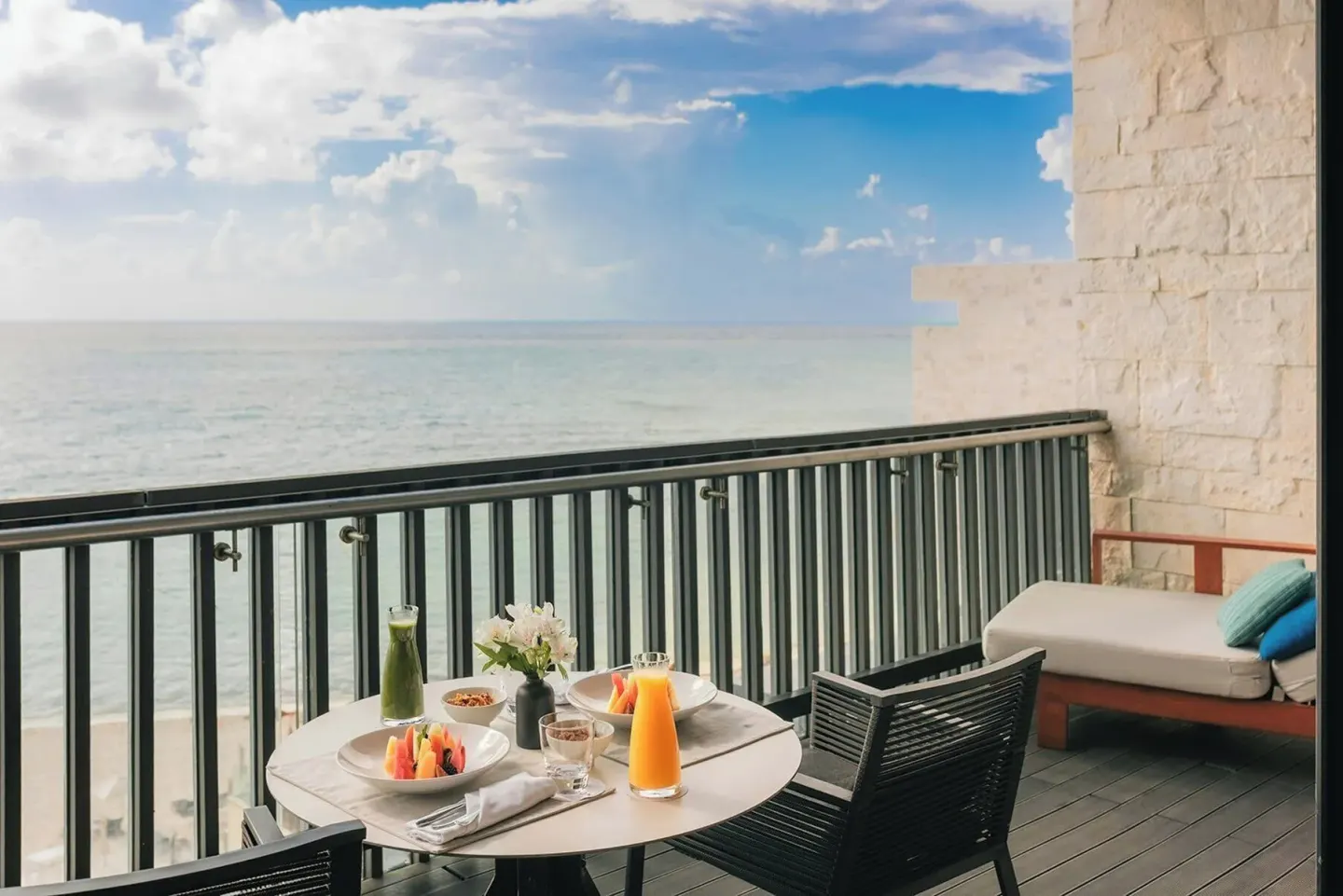 Breakfast table on an oceanfront Premium Room balcony at Devossion By Live Aqua Playa del Carmen.