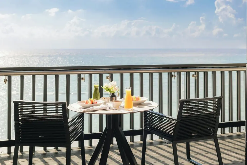 Oceanfront balcony dining setup for a Premium Room at Devossion By Live Aqua Playa del Carmen.