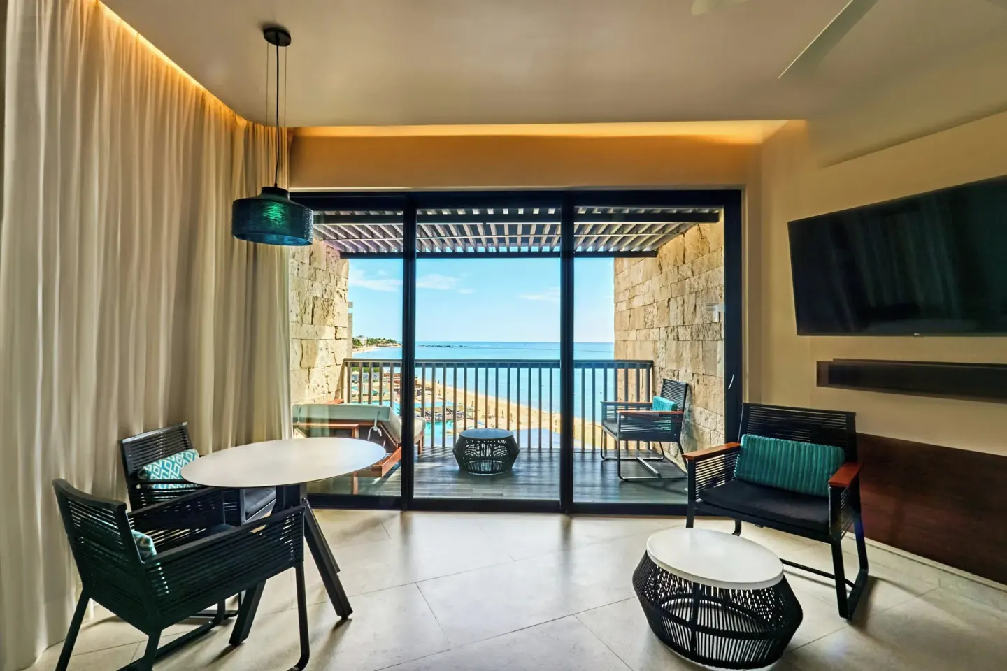 Premium Room sitting area with oceanfront balcony at Devossion By Live Aqua Playa del Carmen.