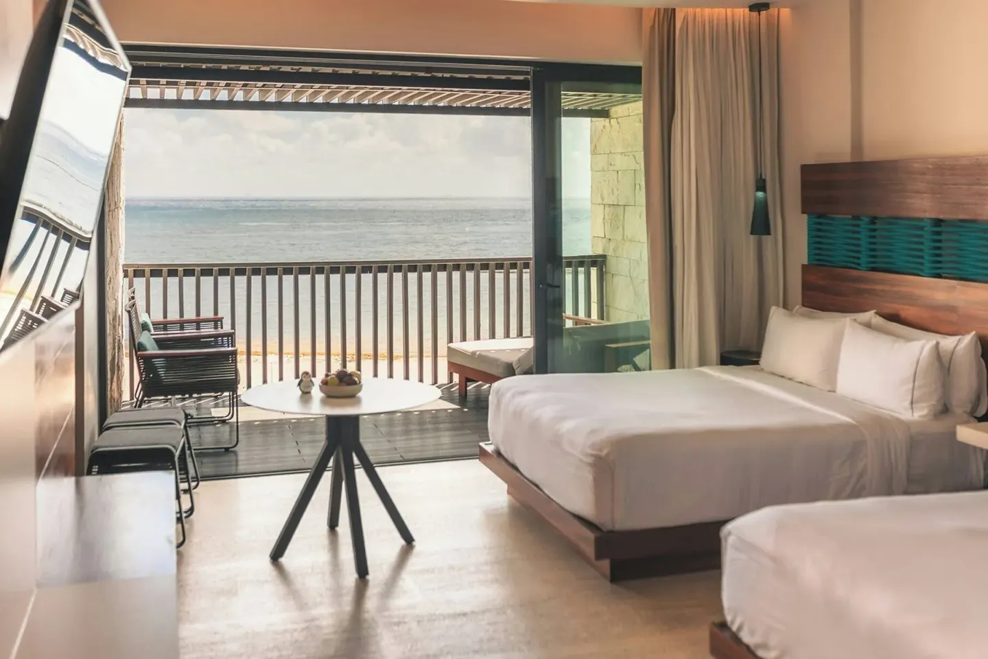 Premium Room with two beds opening to the oceanfront balcony at Devossion By Live Aqua Playa del Carmen.