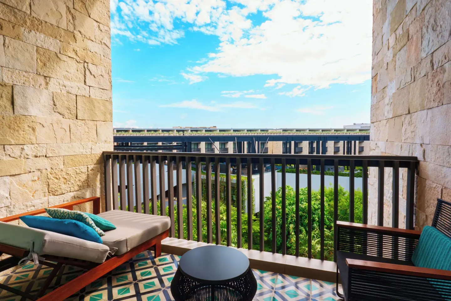 Premium Room balcony with lounge seating at Devossion By Live Aqua Playa del Carmen.