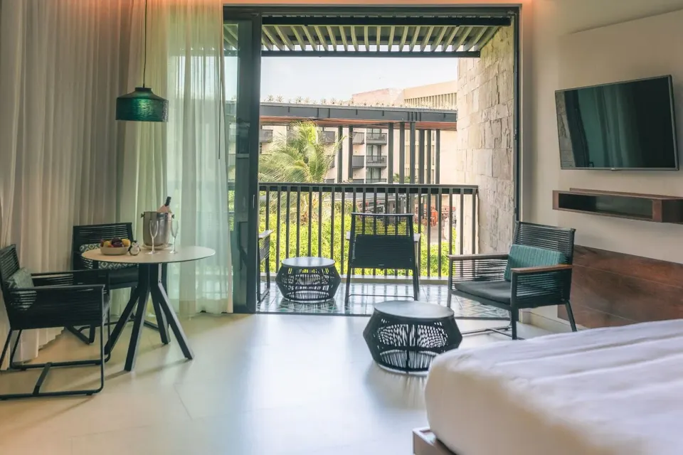 Premium Room sitting area with balcony doors at Devossion By Live Aqua Playa del Carmen.