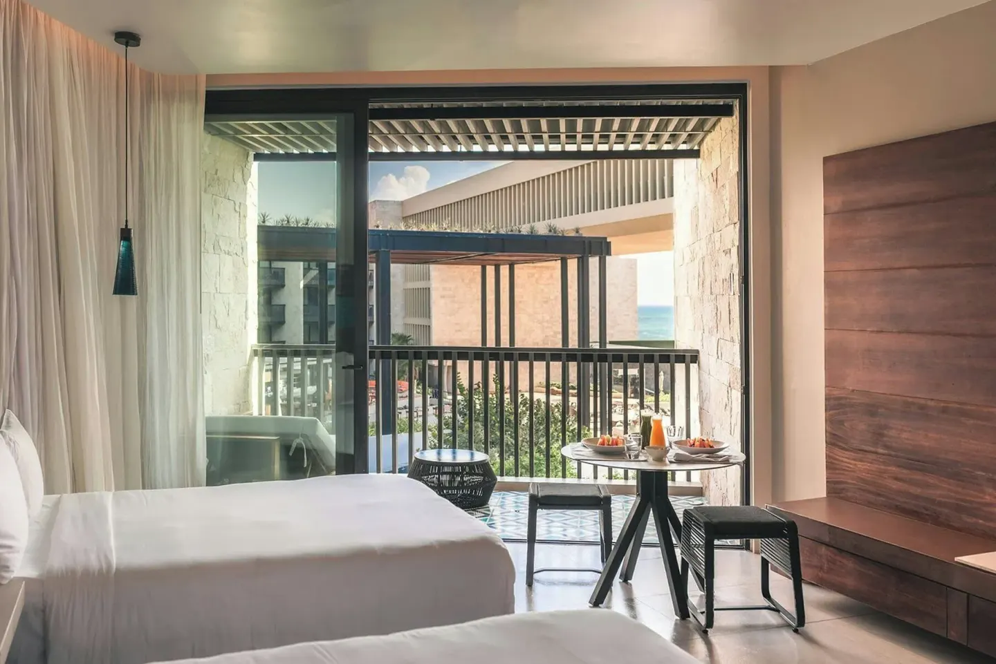 Premium Room two-bed interior opening to a balcony at Devossion By Live Aqua Playa del Carmen.
