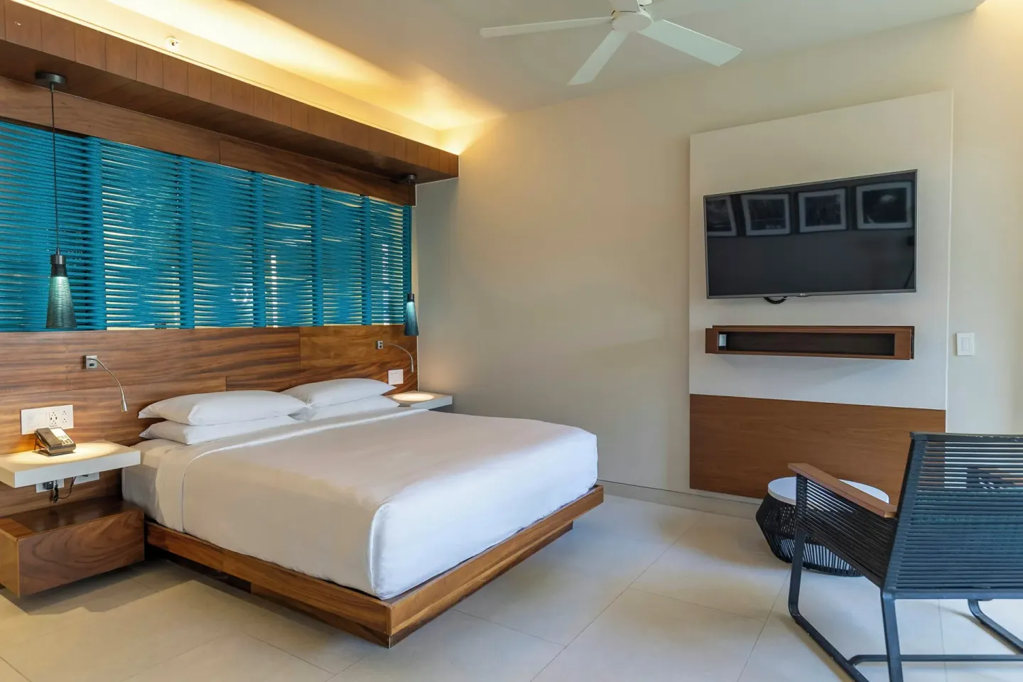 Premium Swim Up room with king bed and wall TV at Devossion By Live Aqua Playa del Carmen.