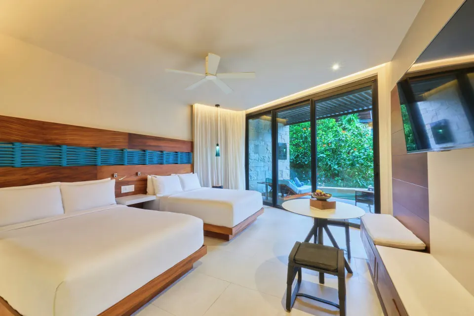 Premium Swim Up room with two beds and pool-view terrace at Devossion By Live Aqua Playa del Carmen.
