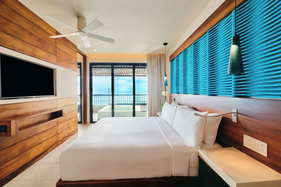 Elixir Plunge Pool suite bedroom with king bed and ocean-facing terrace at Devossion By Live Aqua Playa del Carmen.