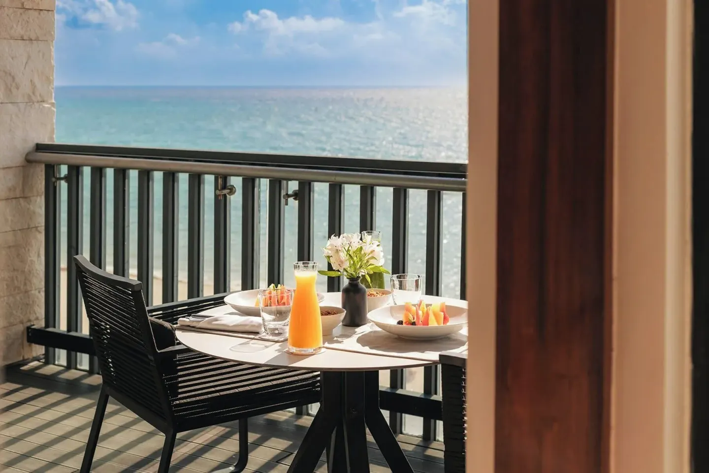 Horizon Suite balcony breakfast table by the ocean at Devossion By Live Aqua Playa del Carmen.