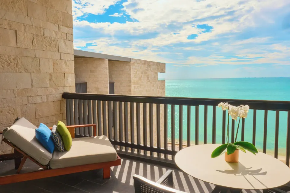 Horizon Suite balcony with lounger and ocean view at Devossion By Live Aqua Playa del Carmen.