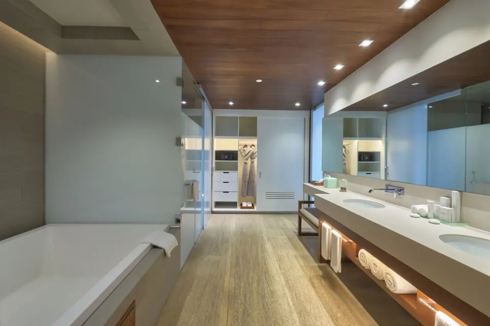 Horizon Suite bathroom with double vanity and tub at Devossion By Live Aqua Playa del Carmen.
