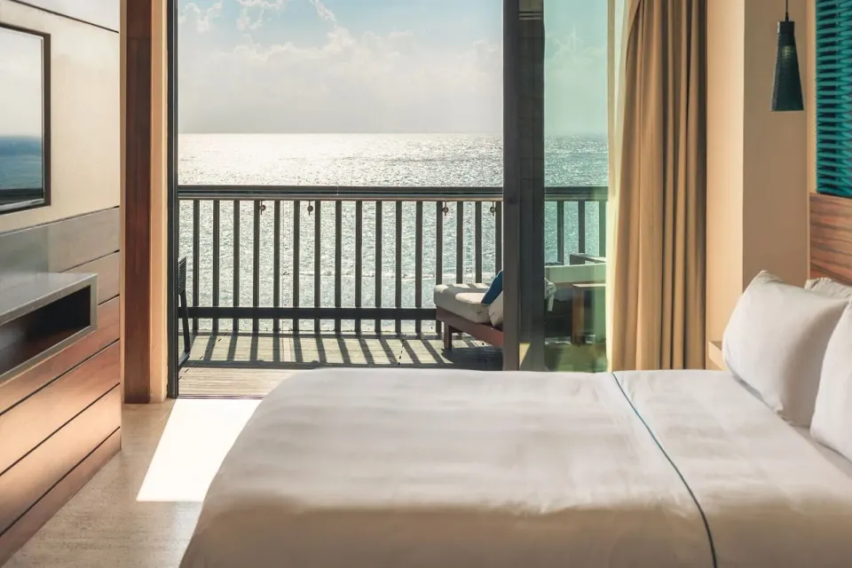 Horizon Suite king bed facing a balcony and ocean at Devossion By Live Aqua Playa del Carmen.