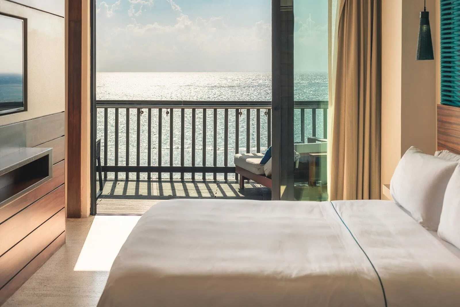 Horizon Suite king bed facing a balcony and ocean at Devossion By Live Aqua Playa del Carmen.