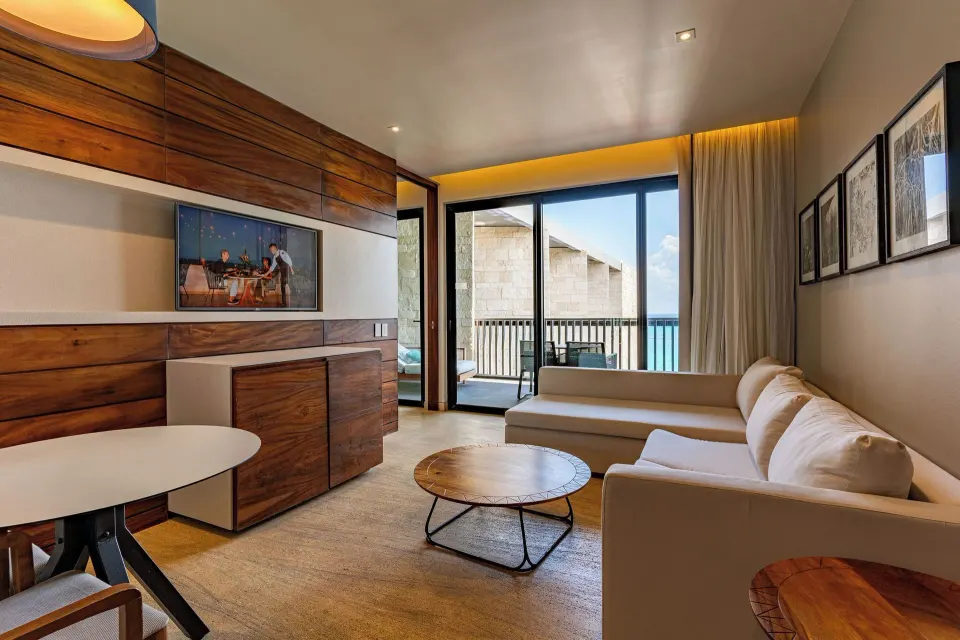 Horizon Suite living room with balcony and ocean view at Devossion By Live Aqua Playa del Carmen.