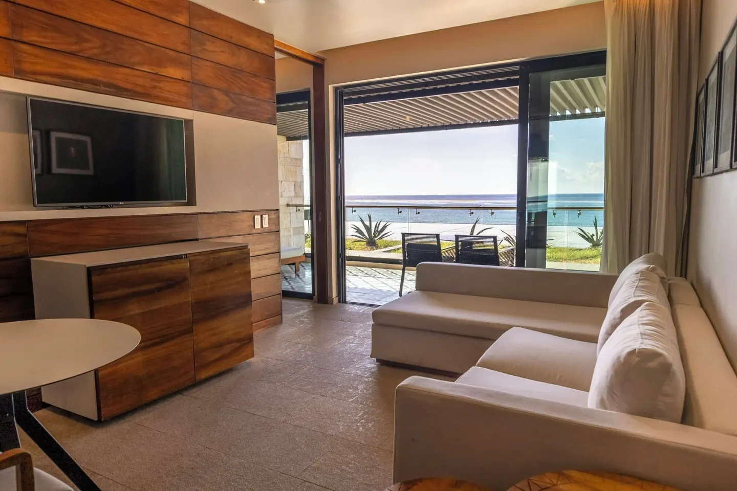Horizon Suite lounge with TV and terrace view at Devossion By Live Aqua Playa del Carmen.