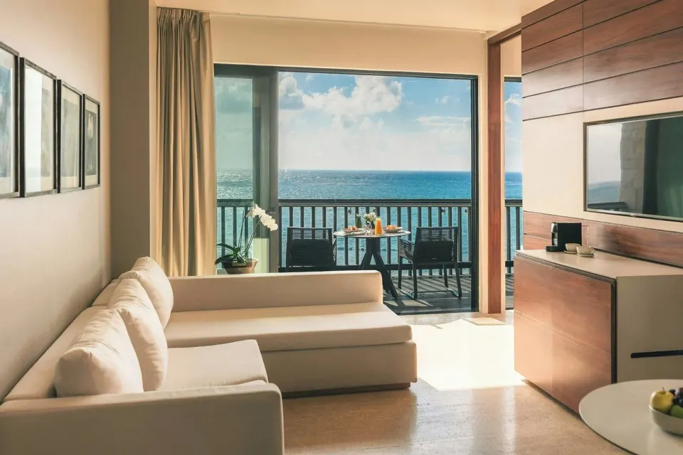 Horizon Suite sitting area with oceanfront balcony at Devossion By Live Aqua Playa del Carmen.