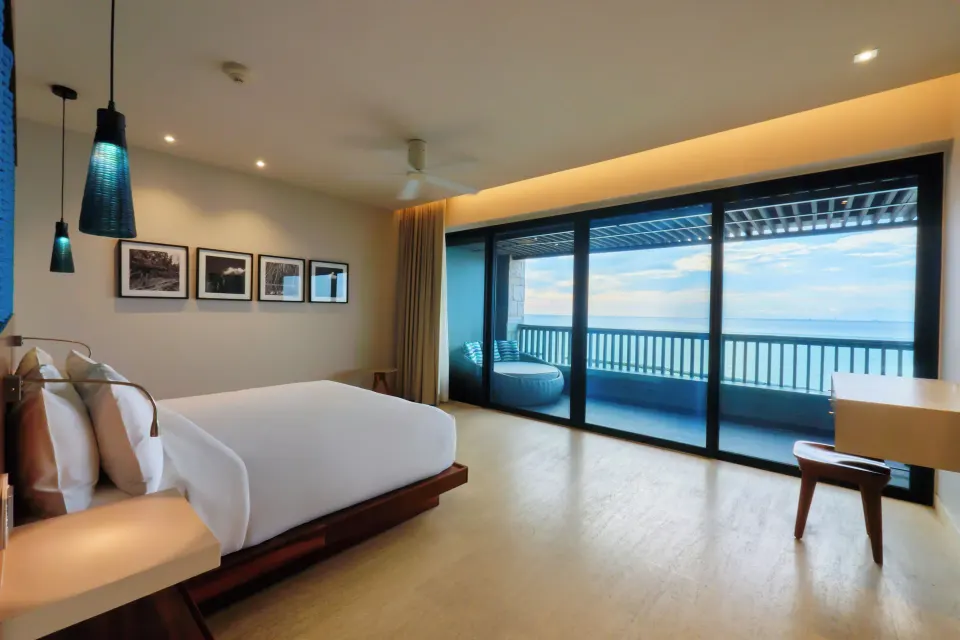 Ocean-view guest room with king bed and balcony at Devossion Playa del Carmen.