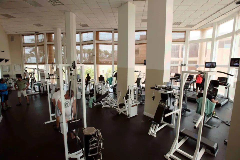 Spacious fitness center with weight machines and treadmills at Divi Aruba Phoenix Beach Resort.