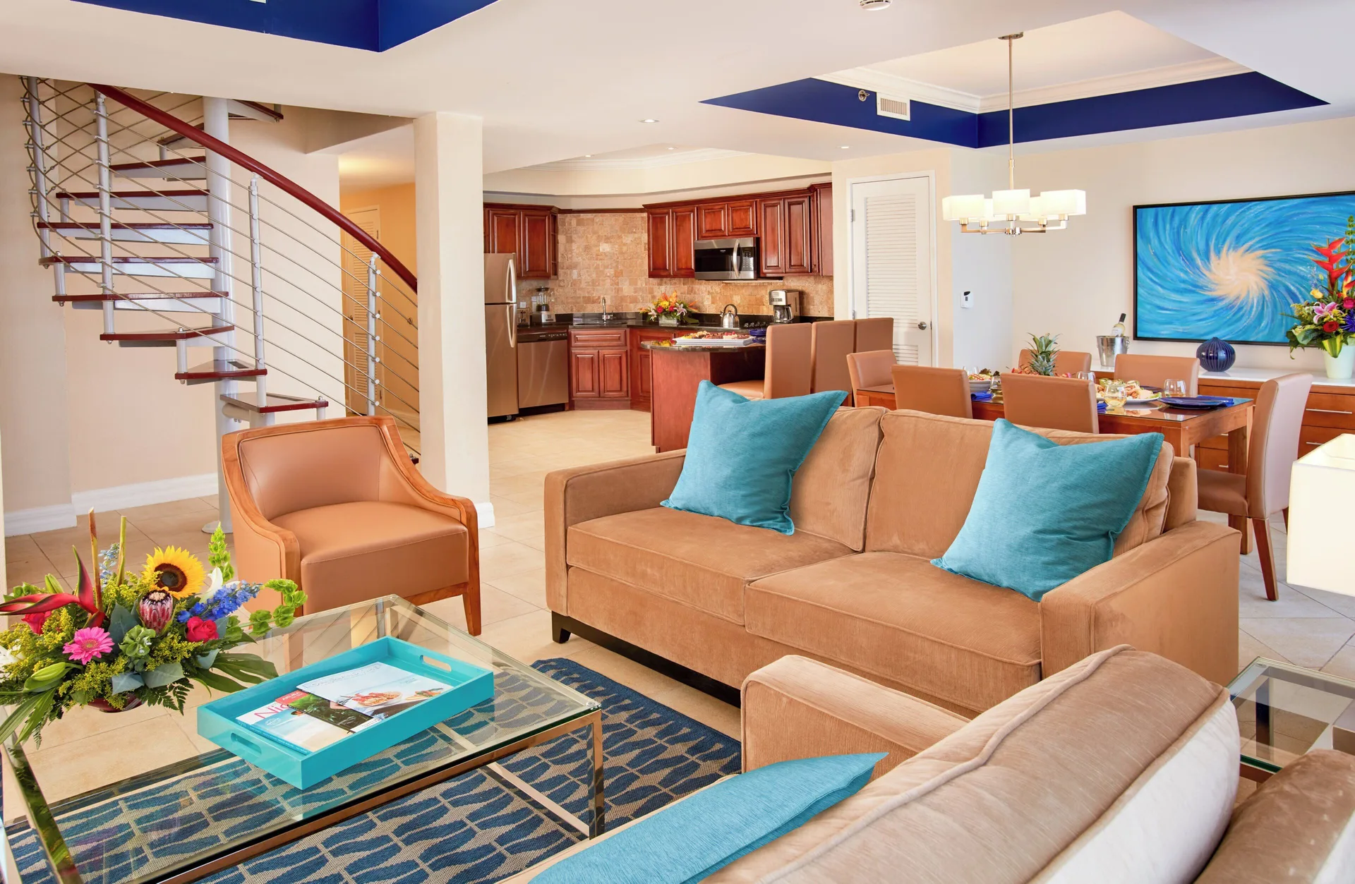 Large suite living room with staircase and kitchen at Divi Aruba Phoenix Beach Resort.