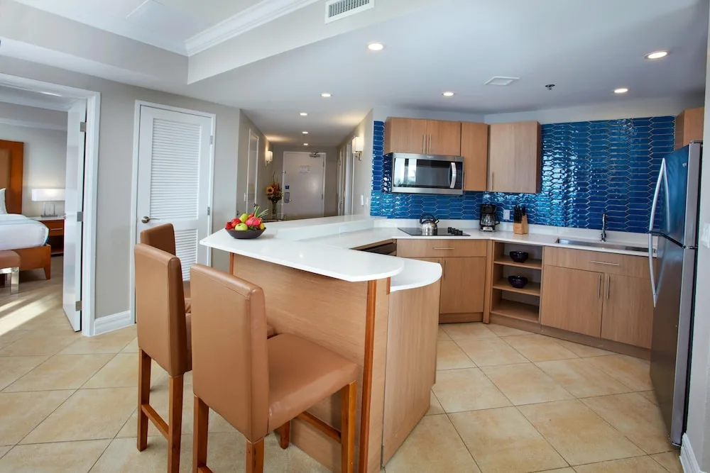 Suite kitchen with blue tile backsplash at Divi Aruba Phoenix Beach Resort.