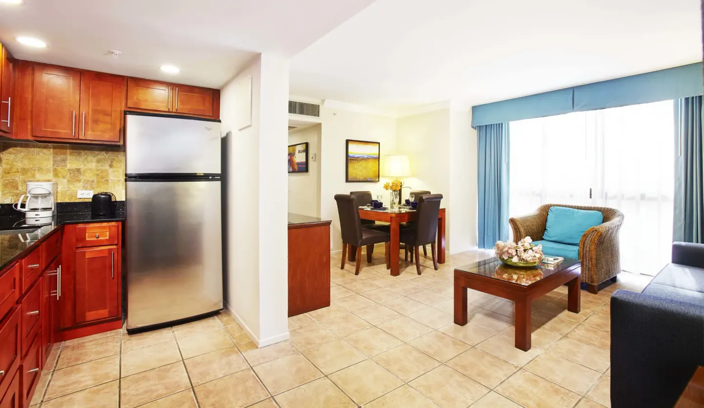 Suite living area with kitchen and dining table at Divi Aruba Phoenix Beach Resort.