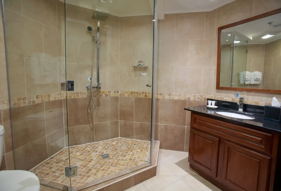 Beach Tower 1 Bedroom Suite bathroom glass shower and vanity at Divi Aruba Phoenix Beach Resort.