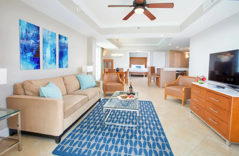 Beach Tower 1 Bedroom Suite living room with sofa and TV at Divi Aruba Phoenix Beach Resort.